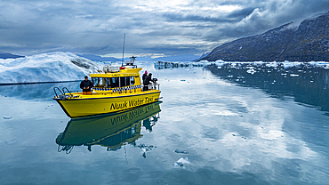 Aerial of a little boat anchoring in the Nuuk Icefjord, Western Greenland, Denmark, Polar Regions