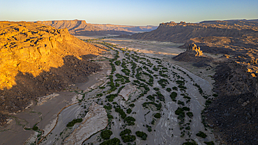 Aerial of the sunset over rocky mountains around Zouar, Tibesti Mountains, Chad, Africa