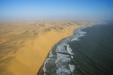 Aerials of sand dunes of the Namib Desert meeting the Atlantic Ocean, Namibia, Africa