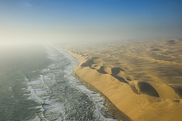 Aerials of sand dunes of the Namib Desert meeting the Atlantic Ocean, Namibia, Africa