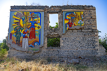 Wall mural displays colorful scenes on ruined structure in Aghdam, Qarabaqh, Azerbaijan showcasing cultural themes