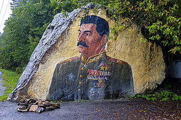Portrait of Stalin on a rock in the Tseysky Gorge, showcasing a historical representation in nature