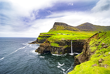 Gasadalur waterfall into the ocean, Vagar, Faroe Islands, Denmark, Europe