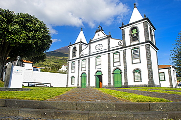 Paroquia de Sao Mateus church below Ponta do Pico, highest mountain of Portugal, Island of Pico, Azores, Portugal, Atlantic, Europe