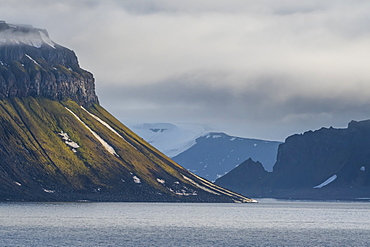 Green cliff in the glacier covered mountains of Franz Josef Land archipelago, Arkhangelsk Oblast, Arctic, Russia, Europe