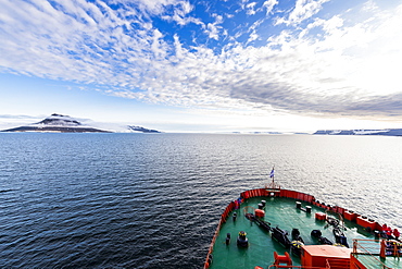 Icebreaker cruising through the flat table mountains covered with ice, Franz Josef Land archipelago, Arkhangelsk Oblast, Arctic, Russia, Europe