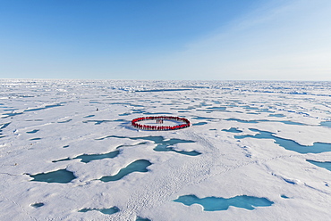 People wearing red forming circle around North Pole, Arctic