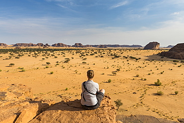 Woman enjoying the beautiful scenery, Ennedi Plateau, UNESCO World Heritage Site, Ennedi region, Chad, Africa