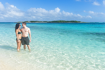 Couple standing in the turquoise wateres of the Exumas, Bahamas, West Indies, Caribbean, Central America