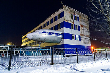 Airplane sticking out of a building, Susuman, Road of Bones, Magadan Oblast, Russia, Eurasia