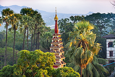 Top of a pagoda rises out of the forest, Kyaikthanian paya, Mawlamyine, Mon state, Myanmar (Burma), Asia