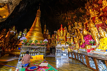 Pilgrims at the gilded Buddha images in the caves at Pindaya, Shan state, Myanmar (Burma), Asia