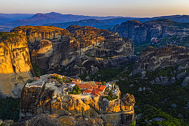 Aerial by drone of the Holy Monastery of Holy Trinity at sunrise, UNESCO World Heritage Site, Meteora Monasteries, Greece, Europe