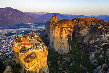 Aerial by drone of the Holy Monastery of Holy Trinity at sunrise, UNESCO World Heritage Site, Meteora Monasteries, Greece, Europe