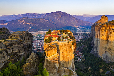 Aerial by drone of the Holy Monastery of Holy Trinity at sunrise, UNESCO World Heritage Site, Meteora Monasteries, Greece, Europe