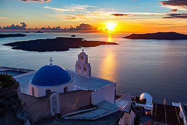 Sunset over the volcanic islands of Santorini and Anastasi Orthodox Church at sunset, Fira, Santorini, Cyclades, Greek Islands, Greece, Europe