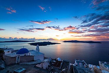 Sunset over the volcanic islands of Santorini and Anastasi Orthodox Church at sunset, Fira, Santorini, Cyclades, Greek Islands, Greece, Europe