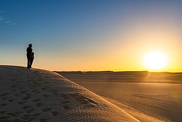 Tuareg standing on a sand dune in the Tenere Desert at sunrise, Sahara, Niger, Africa