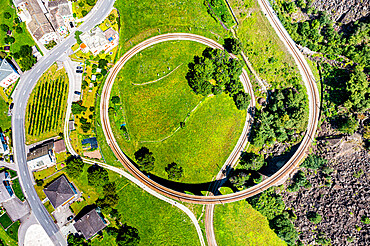 Aerial of the Brusio spiral viaduct, UNESCO World Heritage Site, Rhaetian Railway, Switzerland, Europe