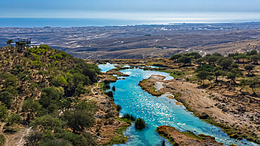 Aerial of a turquoise river in Wadi Darbat, Salalah, Oman, Middle East