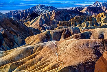 Hikers in the Colourful sandstone formations, Zabriskie Point Death valley, California, USA