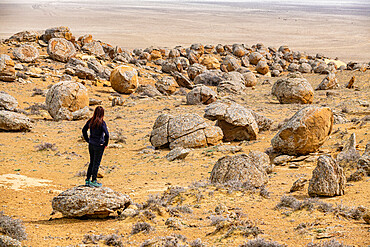 Woman standing in the Torysh (The Valley of Balls), Shetpe, Mangystau, Kazakhstan, Central Asia, Asia