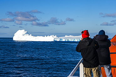 Tourists watching an iceberg floating in the South Orkney Islands, Antarctica, Polar Regions