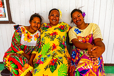 Colourful dressed women with flowers in their hair, Hikueru, Tuamotu archipelago, French Polynesia, South Pacific, Pacific