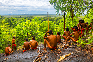 Yanomami tribe sitting on a giant rock in the jungle, southern Venezuela, South America