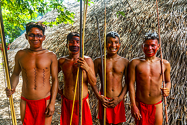 Young men with colour on their faces posing with bows and arrows, Yanomami tribe, southern Venezuela, South America