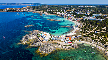 Aerial of the turquoise waters and white sand beach of the Pujols beach, Formentera, Balearic Islands, Spain, Mediterranean, Europe