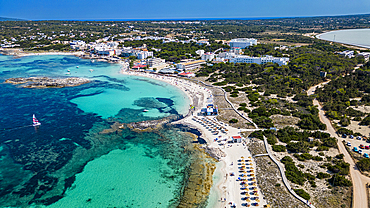 Aerial of the turquoise waters and white sand beach of the Pujols beach, Formentera, Balearic Islands, Spain, Mediterranean, Europe