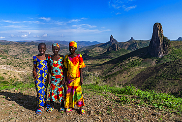 Three Kapsiki tribal girls in front of the lunar landscape, Rhumsiki, Mandara mountains, Far North province, Cameroon, Africa