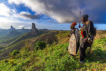 Kapsiki tribal men in front of the lunar landscape of Rhumsiki peak, Rhumsiki, Mandara mountains, Far North province, Cameroon, Africa