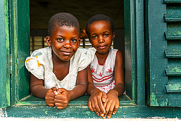 Young school kids looking out from a window, Ciudad de la Paz, Rio Muni, Equatorial Guinea, Africa