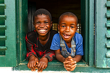 Young school kids looking out from a window, Ciudad de la Paz, Rio Muni, Equatorial Guinea, Africa