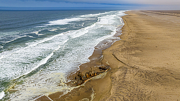 Aerial of a shipwreck on a beach in the Iona National Park, Namibe, Angola, Africa