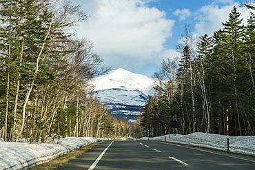 Road leading through the snow capped mountains of the Daisetsuzan National Park, UNESCO World Heritage Site, Hokkaido, Japan, Asia