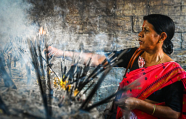 Woman devotee and incense sticks, Kamakhya Temple, Guwahati, Assam, India, Asia