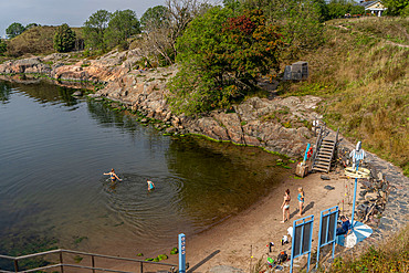 Visitors swimming at beach to Suomenlinna island near Helsinki,Finland,Europe