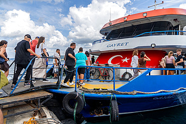 Views and passengers at ferry trip down the Bosphorus Strait with palaces,mosques and mansions from Asian and European sides, in Istanbul, Turkey, Türkiye