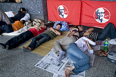 China migrant workers from the countryside waiting outside guangzhou train station, guangdong province