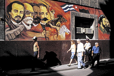 Mural, cuba. Havana. Pedestrians walking past a wall painting in the old part of havana