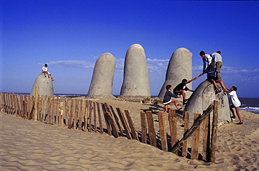 Uruguay. Punta del este, playa brava. Children playing