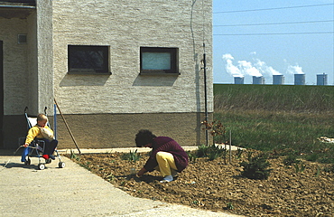 Slovakia. Family home with thermo-nuclear power station in background.