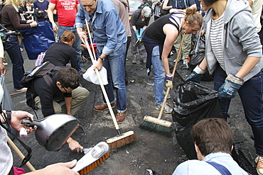 Local community get together to clear damage caused by rioters in Hackney, London, UK ;