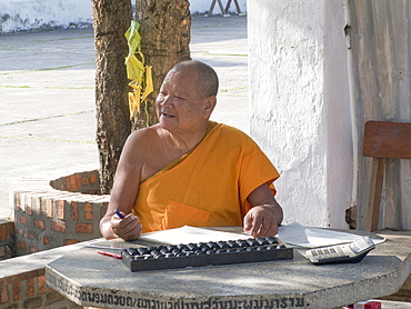 Laos, head monk at a monastery in the holy city of luang prabang