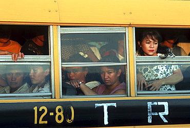 Honduras. Bus loaded with workers leaving textile maquila factory, san pedro