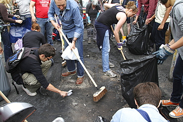 Local community get together to clear damage caused by rioters in Hackney, London, UK ;