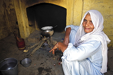 Village life, pakistan. Woman cooking food in a stove in a punjabi village